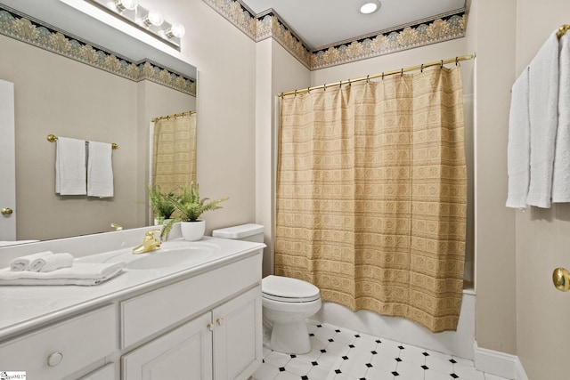 bathroom featuring toilet, shower / bath combo with shower curtain, and vanity