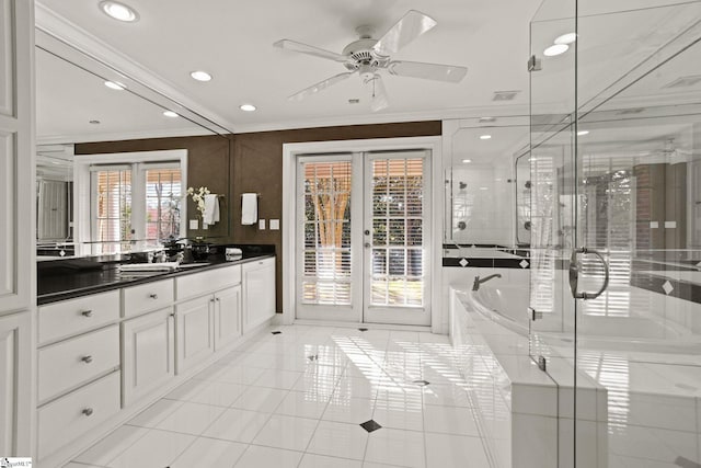 full bath with french doors, tile patterned floors, crown molding, vanity, and a bath