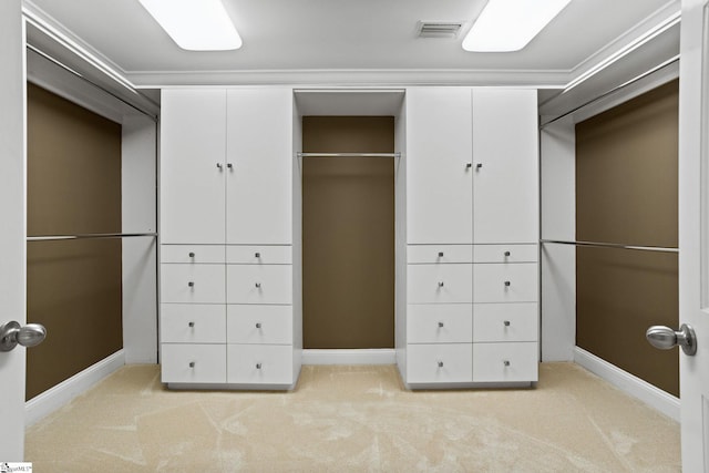 spacious closet featuring visible vents and light carpet