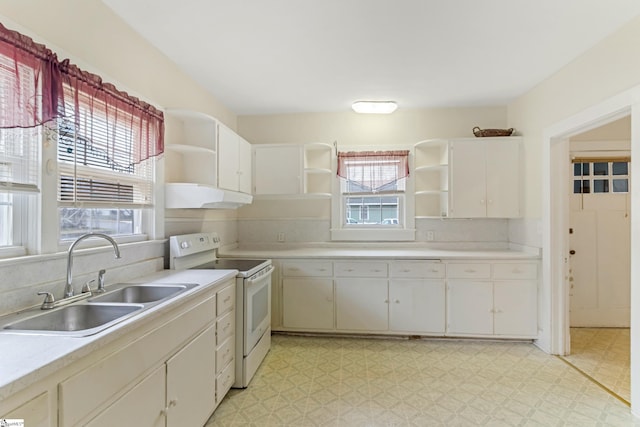 kitchen featuring light floors, under cabinet range hood, electric range, a sink, and open shelves