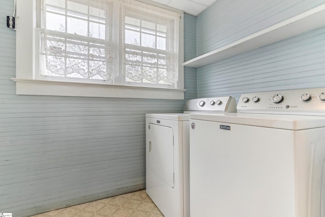 laundry room with laundry area, washing machine and dryer, plenty of natural light, and light floors