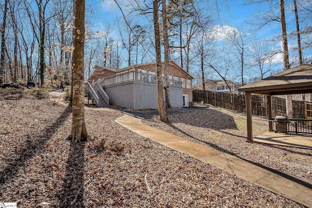 view of yard with a deck, fence, and stairway