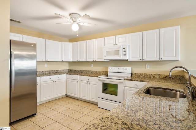 kitchen featuring white appliances, white cabinets, and a sink