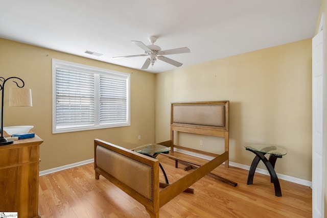 bedroom with light wood-style flooring, visible vents, and baseboards