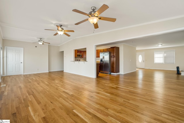 unfurnished living room featuring light wood-style floors, baseboards, and ornamental molding