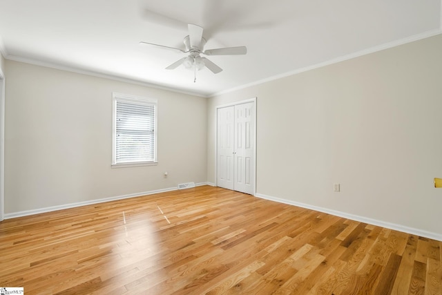 interior space featuring ornamental molding, light wood-type flooring, and baseboards