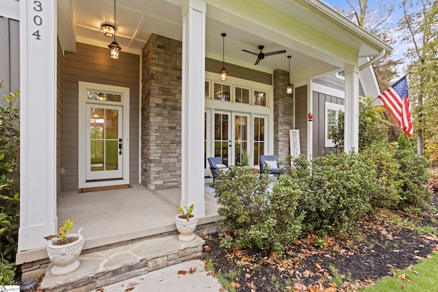 view of exterior entry featuring covered porch and french doors