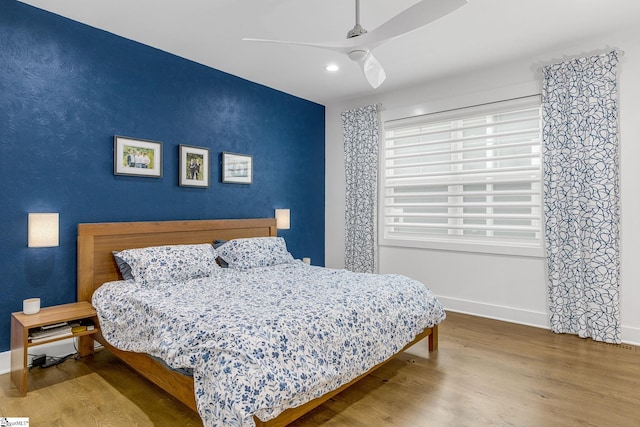 bedroom featuring ceiling fan, recessed lighting, wood finished floors, and baseboards