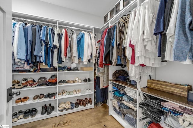 walk in closet featuring wood finished floors and visible vents