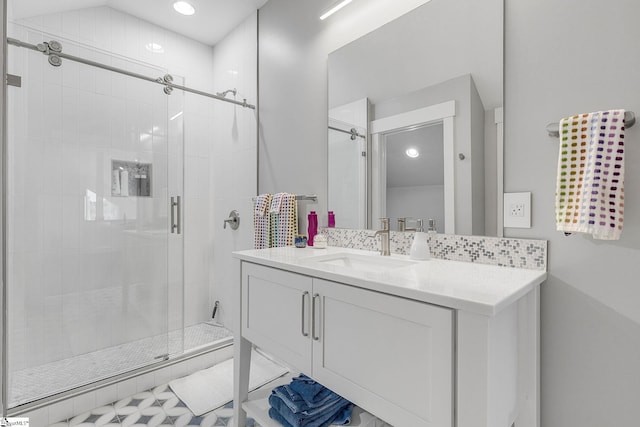 bathroom with a stall shower and vanity