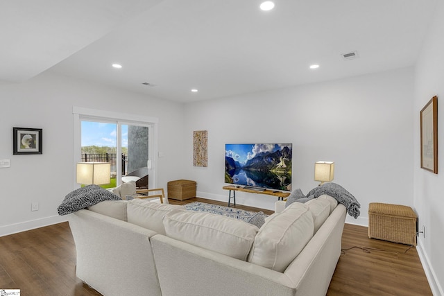 living area featuring baseboards, dark wood-style flooring, and recessed lighting