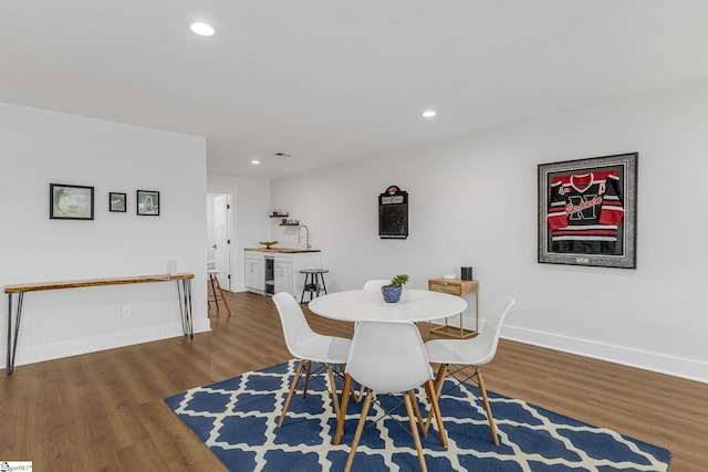 dining room featuring recessed lighting, wood finished floors, and baseboards