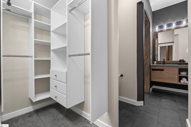 walk in closet featuring a sink