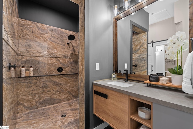 bathroom featuring visible vents, vanity, and tiled shower