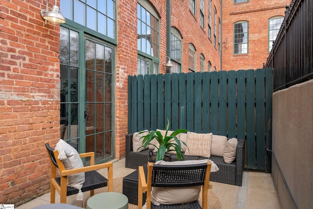 view of patio / terrace with fence and an outdoor living space