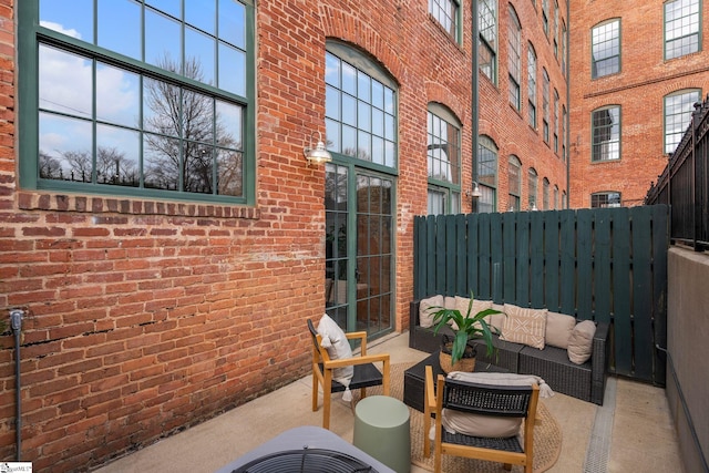 view of patio featuring fence and an outdoor living space