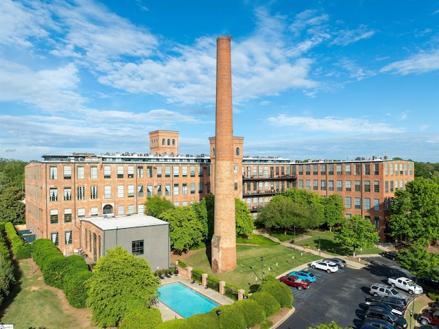 view of building exterior with a view of city and uncovered parking