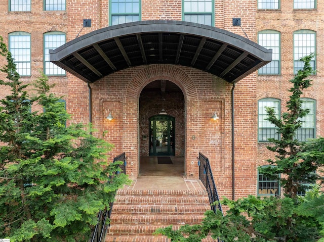 doorway to property featuring brick siding