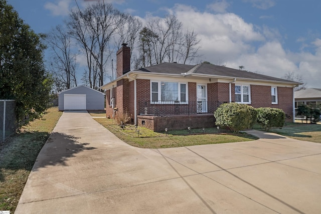 bungalow with brick siding, a detached garage, a chimney, concrete driveway, and an outdoor structure