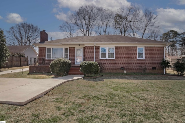 ranch-style house featuring a chimney, a front yard, fence, and brick siding