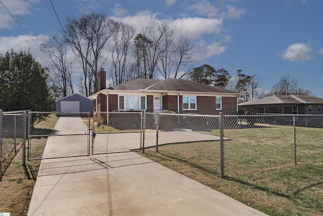 view of front of house with a fenced front yard, a gate, brick siding, and driveway