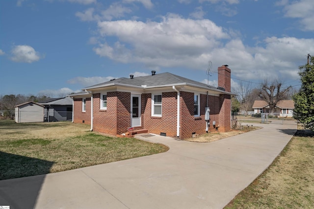 view of home's exterior with a yard, brick siding, crawl space, and a chimney