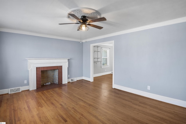 unfurnished living room with ornamental molding, visible vents, baseboards, and wood finished floors