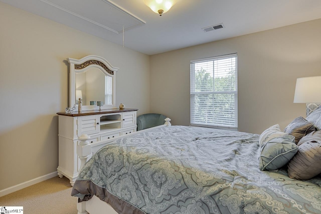 bedroom featuring baseboards, carpet flooring, visible vents, and attic access