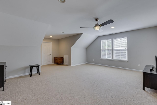 additional living space with carpet floors, baseboards, a ceiling fan, and lofted ceiling