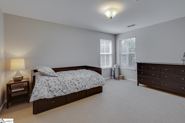 bedroom with carpet, visible vents, and baseboards