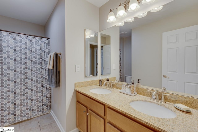 bathroom featuring a shower with curtain, double vanity, a sink, and tile patterned floors