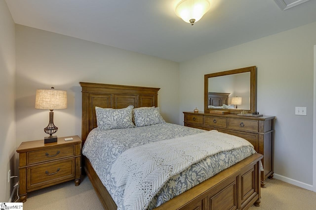 bedroom with baseboards, visible vents, and light colored carpet