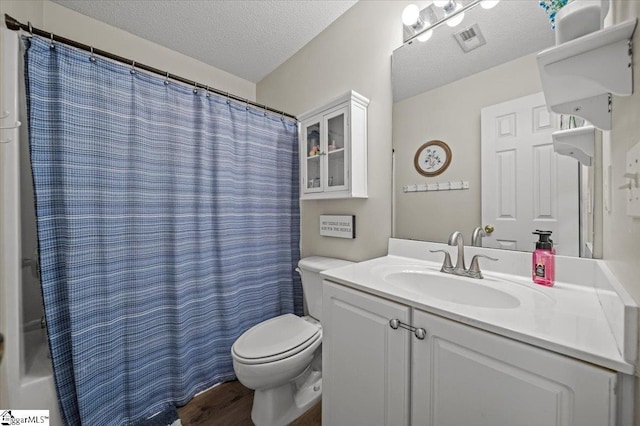 full bath with a textured ceiling, toilet, wood finished floors, vanity, and visible vents