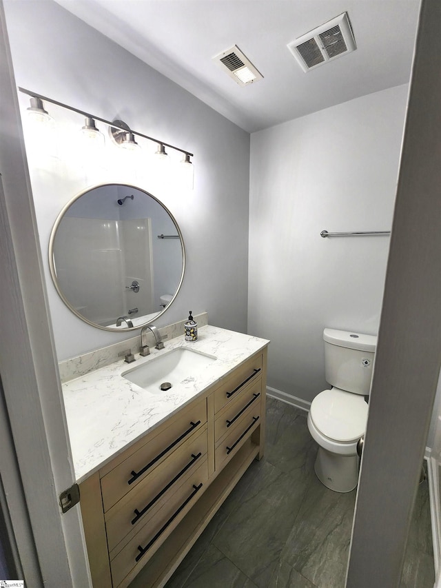 bathroom featuring toilet, vanity, visible vents, and baseboards