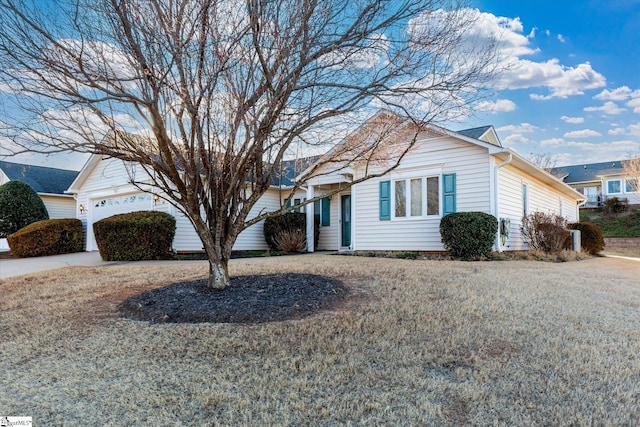 ranch-style house featuring an attached garage and driveway