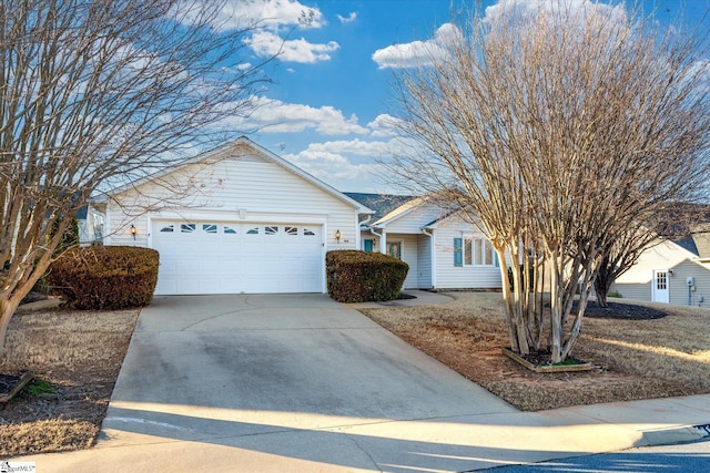 ranch-style home with an attached garage and concrete driveway