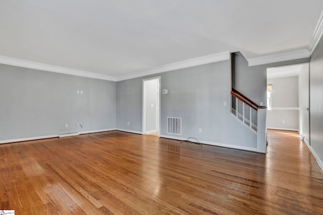 unfurnished living room with stairway, baseboards, visible vents, and wood finished floors