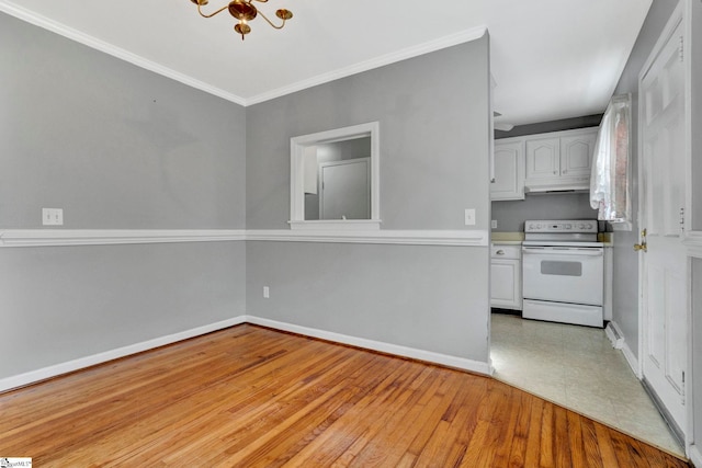 kitchen with white electric range oven, baseboards, white cabinetry, and light wood-style floors