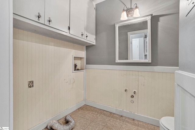 washroom featuring a wainscoted wall and hookup for an electric dryer