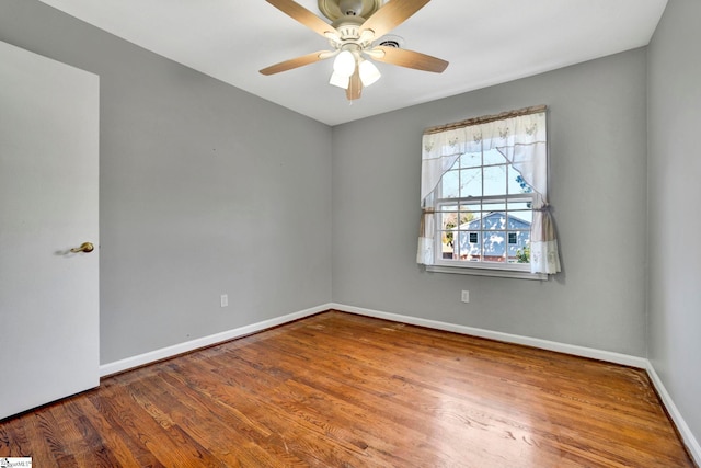 unfurnished room featuring ceiling fan, baseboards, and wood finished floors