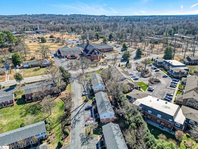 drone / aerial view featuring a forest view and a residential view