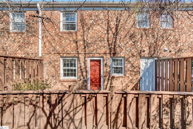 view of front of property with fence and brick siding