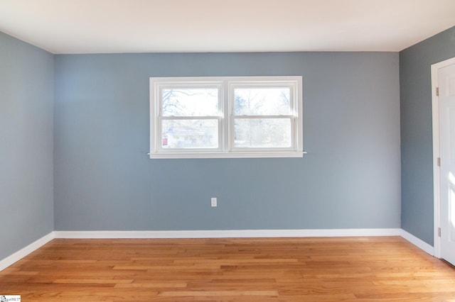 unfurnished room featuring light wood finished floors and baseboards