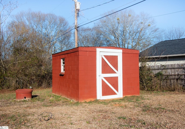 view of shed featuring fence