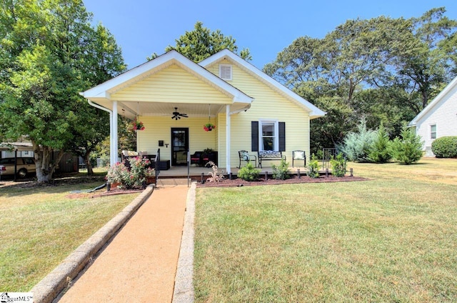 bungalow-style house with a front lawn, a porch, and a ceiling fan