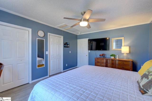 bedroom with visible vents, ceiling fan, wood finished floors, crown molding, and a textured ceiling