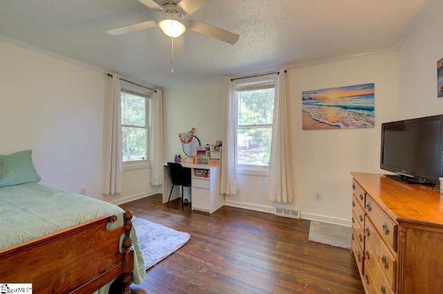 bedroom with multiple windows, visible vents, dark wood-type flooring, and ornamental molding