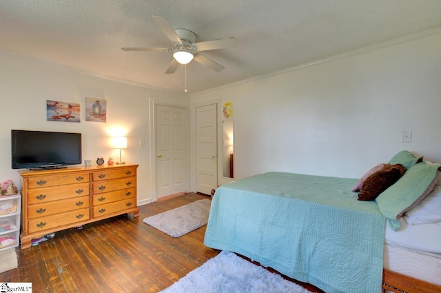 bedroom featuring a ceiling fan, crown molding, a textured ceiling, and hardwood / wood-style floors