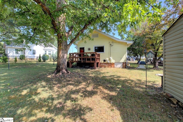 view of yard featuring fence and a wooden deck