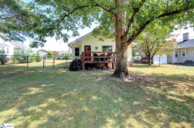 view of yard with a gate, a fenced backyard, and a wooden deck